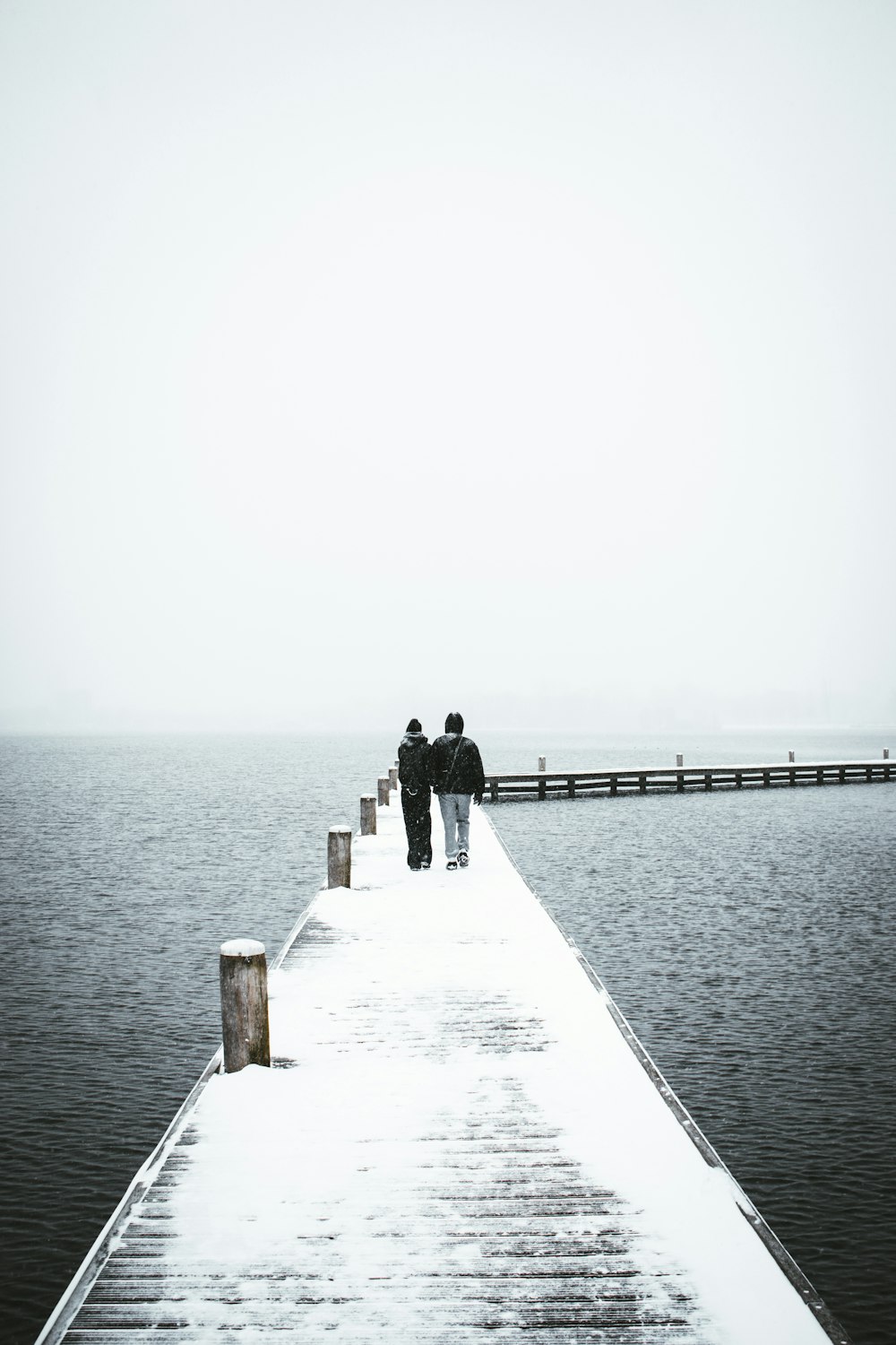 man in black jacket standing on dock during daytime