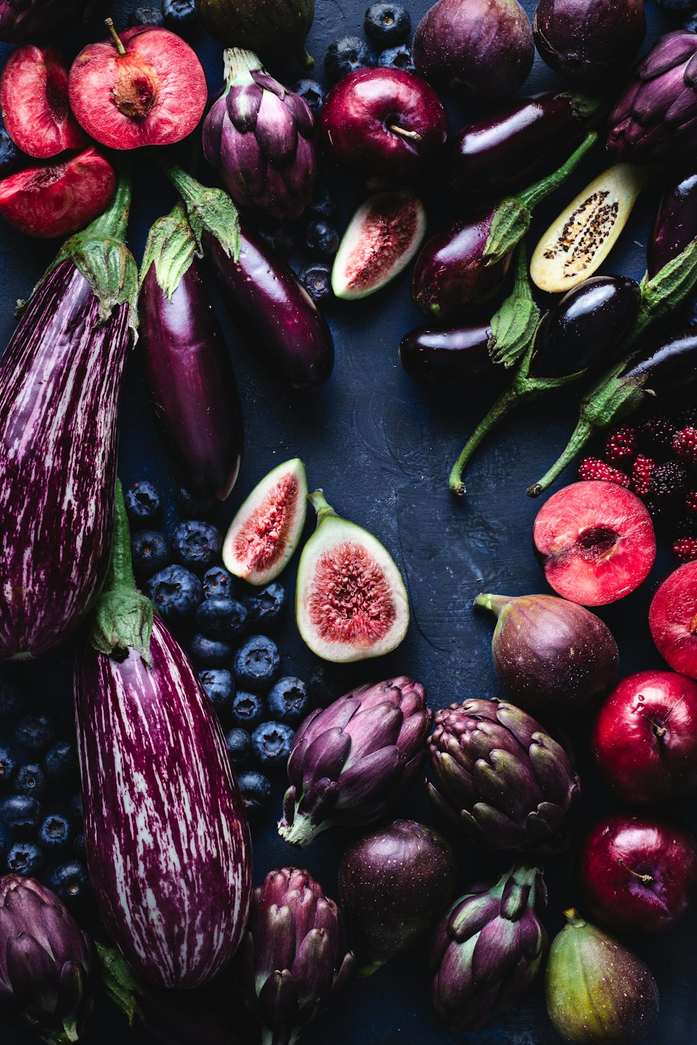 sliced pomegranate fruits on black table