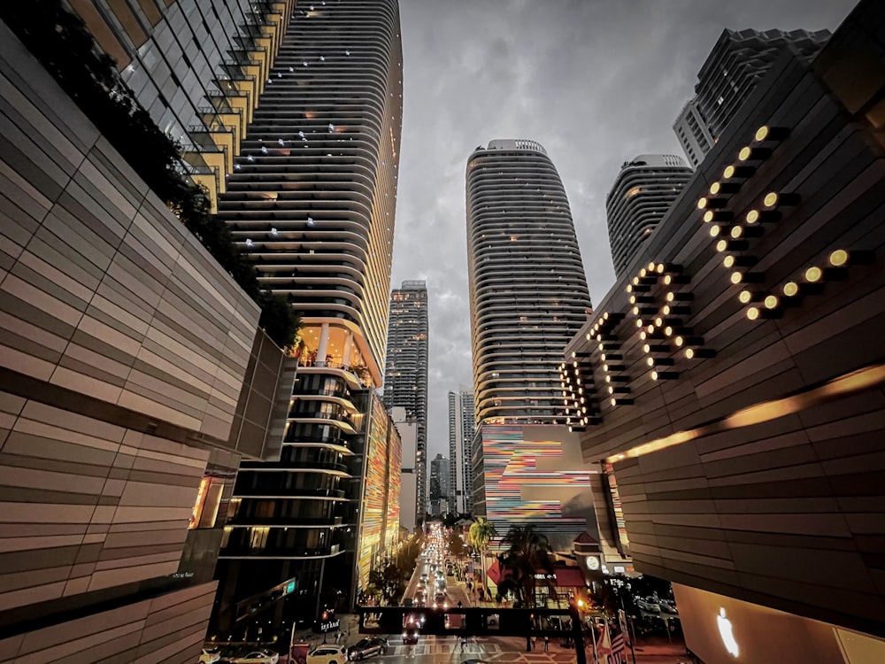 people walking on street near high rise buildings during night time