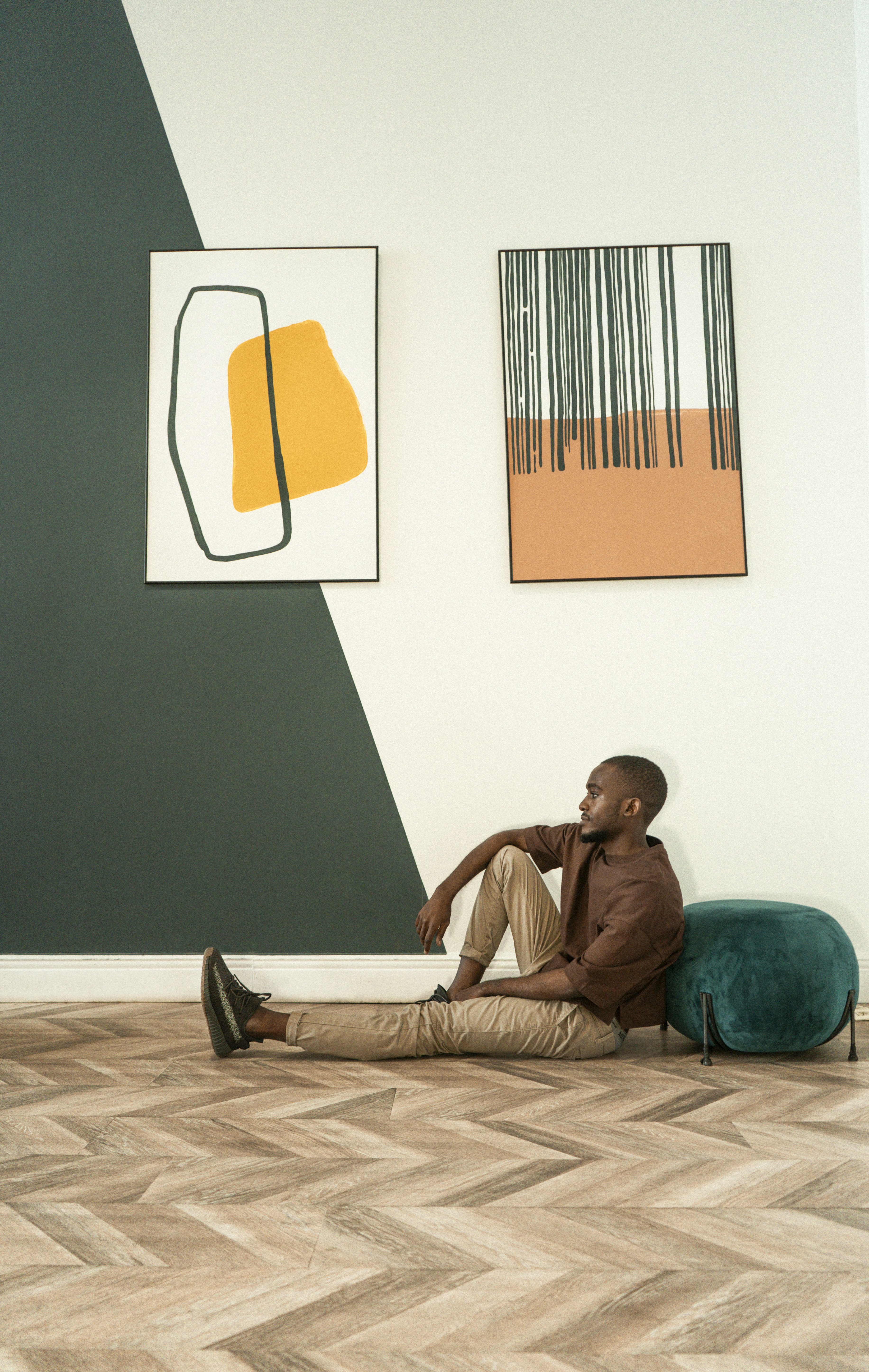 man in red dress shirt sitting on bed