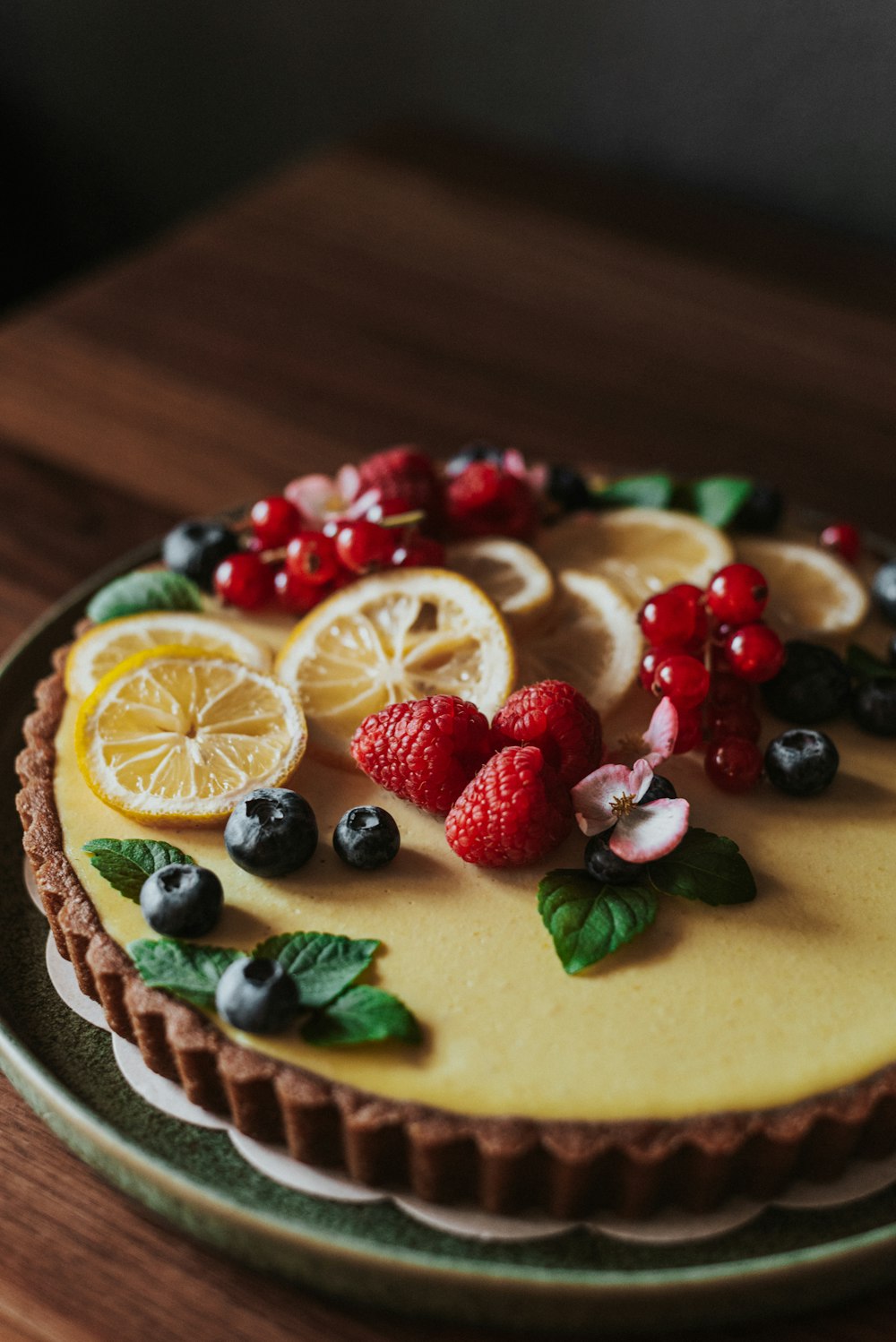 sliced lemon and strawberry on white ceramic plate