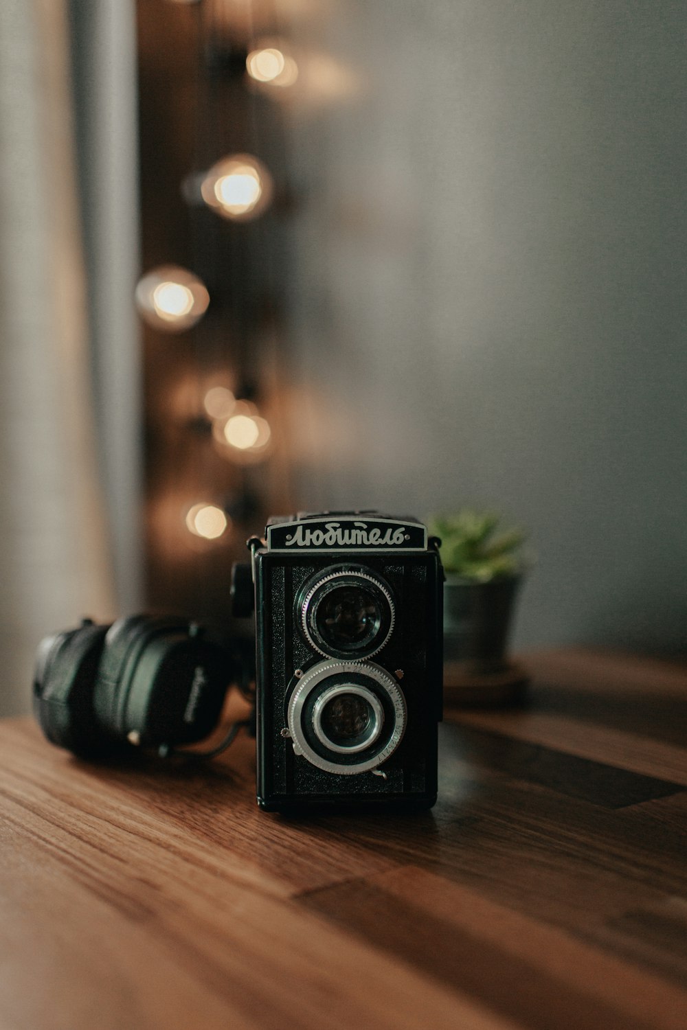 black nikon dslr camera on brown wooden table