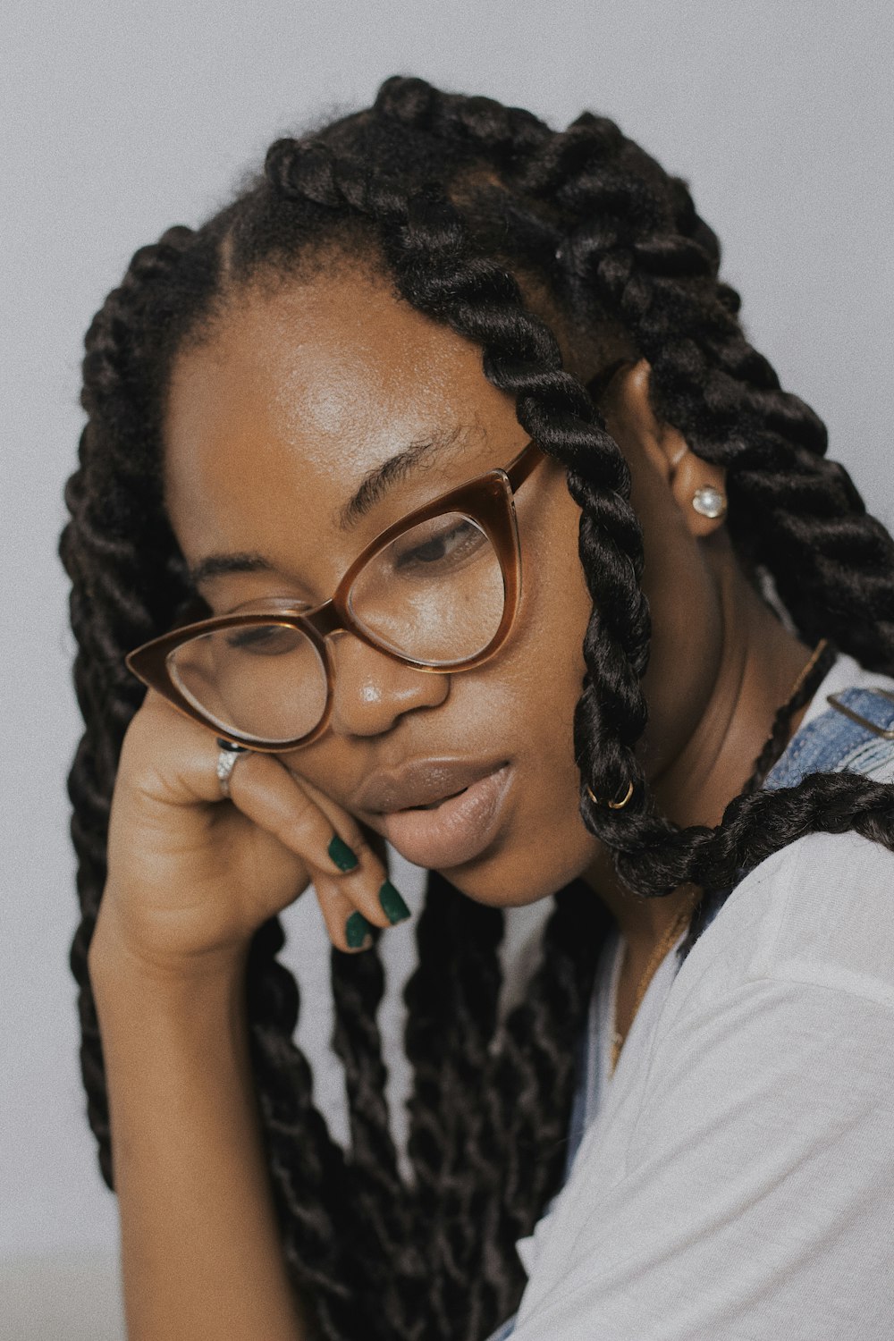 woman in white shirt wearing black framed eyeglasses