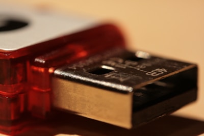 Close-up of a USB drive being examined for data recovery by a skilled technician.