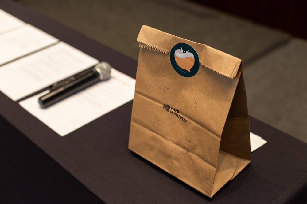 brown paper bag on black wooden table