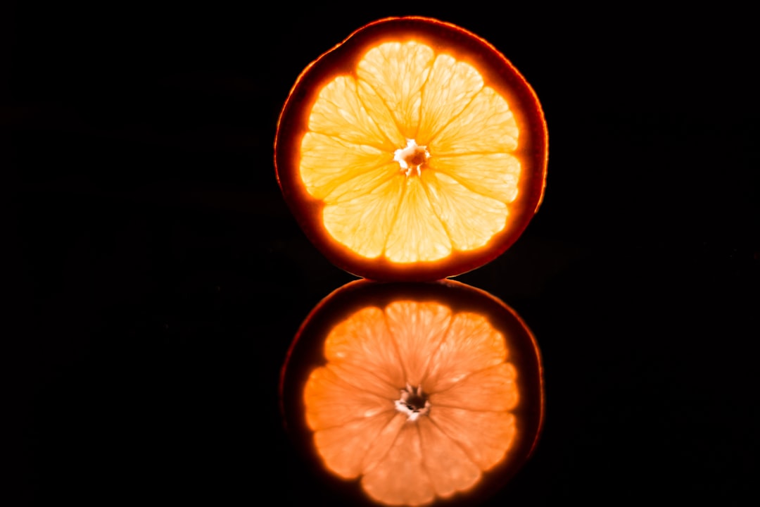 sliced orange fruit on black background