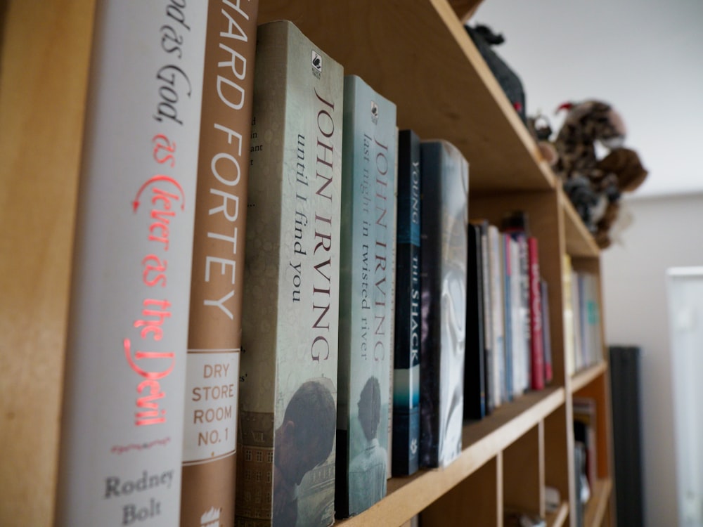 books on brown wooden shelf