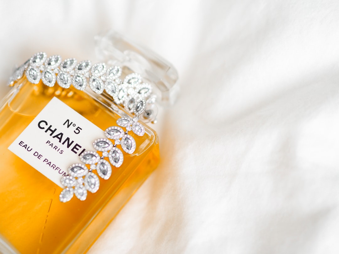 clear glass bottle on white textile