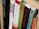 A close-up view of books arranged on a wooden shelf, with titles focusing on theological and religious themes. The spines of the books display various colors and fonts, suggesting a scholarly collection.