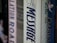 A row of books on a shelf focuses on the spine of a book titled 'The Message'. The titles of other books are partially visible, providing a sense of a personal library or a collection.