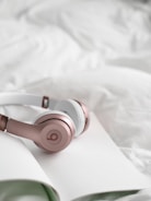 Sleep headphones resting on pillow — designed for light sleepers who need brown noise and gentle amb