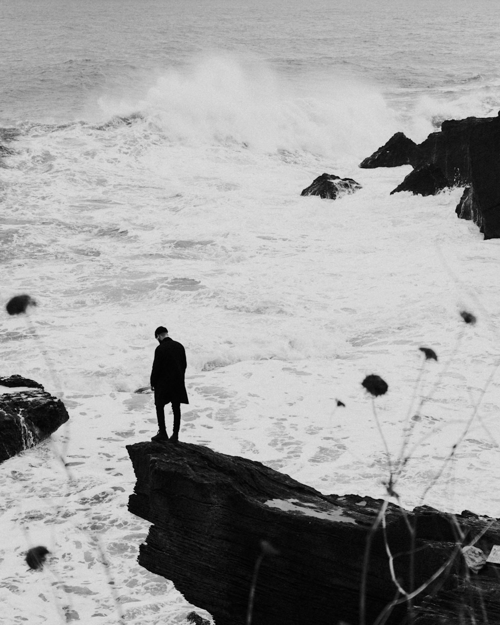 man in black shirt standing on snow covered ground