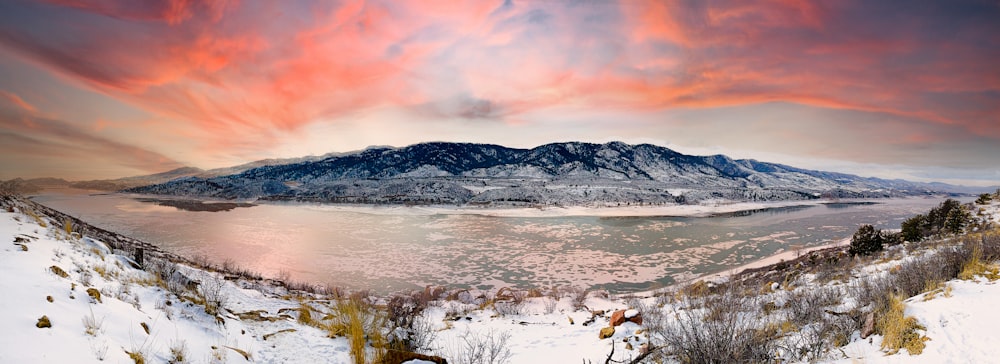 white and brown mountains near body of water during daytime