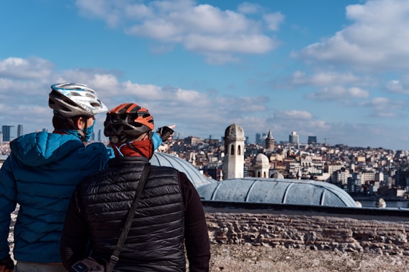 man in black jacket and helmet standing on top of the building during daytime