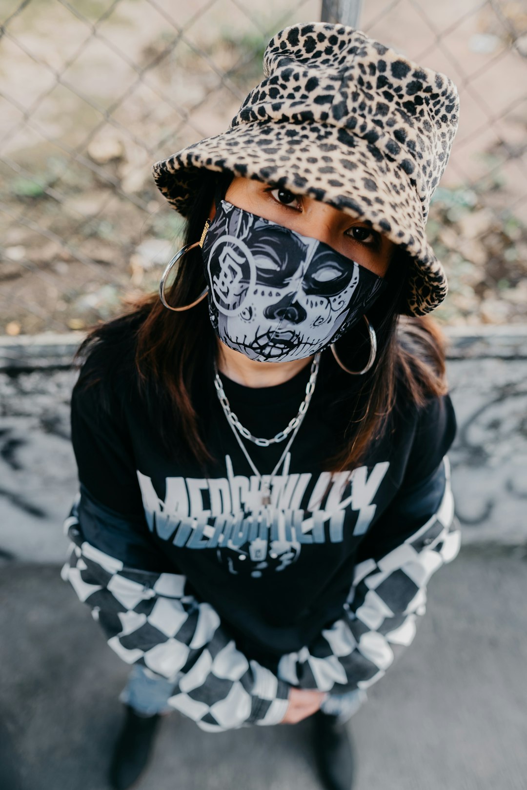 person wearing black and white skull mask