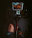 A man happily following a cardio app workout on his tablet at home.