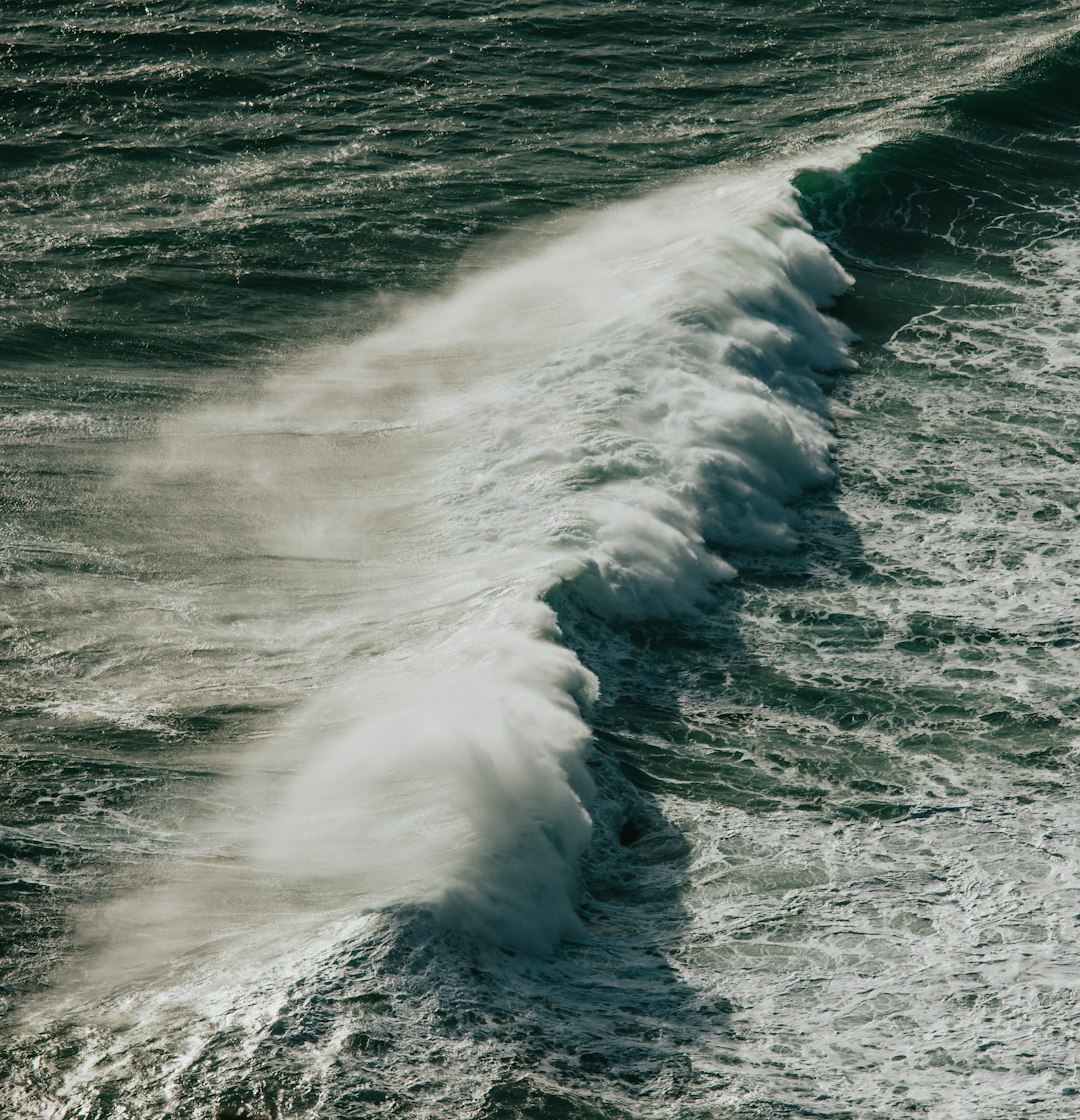 ocean waves crashing on shore during daytime