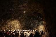 A group of players mining resources together in a dark cave.