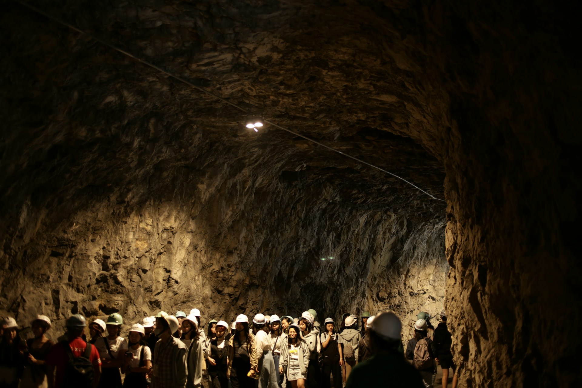 people in a tunnel with lights