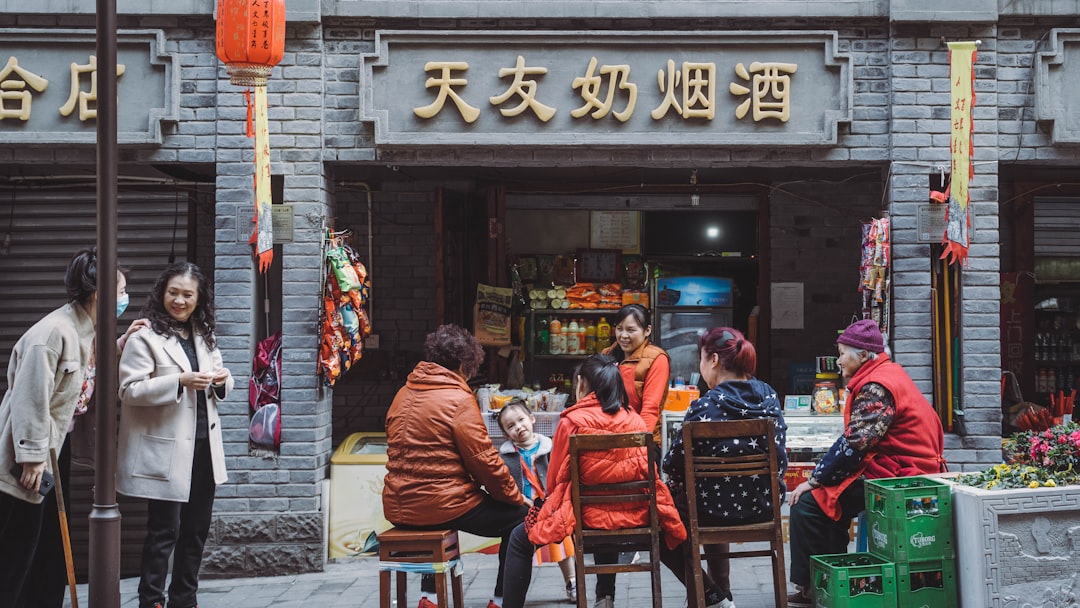 people sitting on chair in front of store during daytime