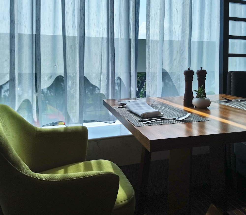 white sheer window curtain near brown wooden table