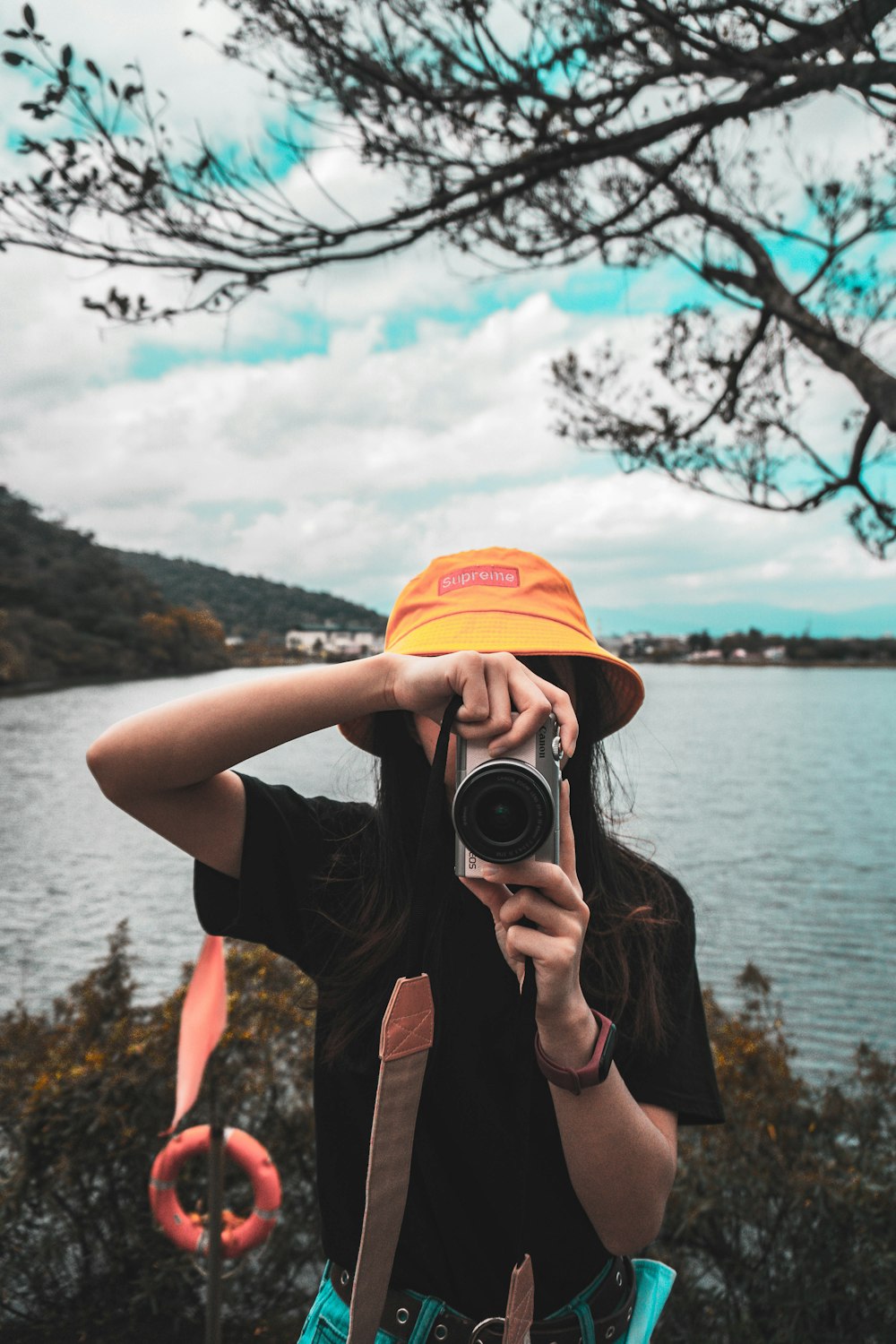 man in black t-shirt holding black camera