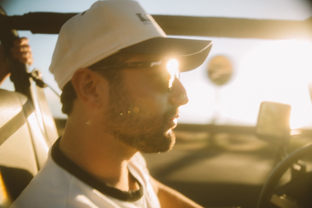 man in white fitted cap and white tank top