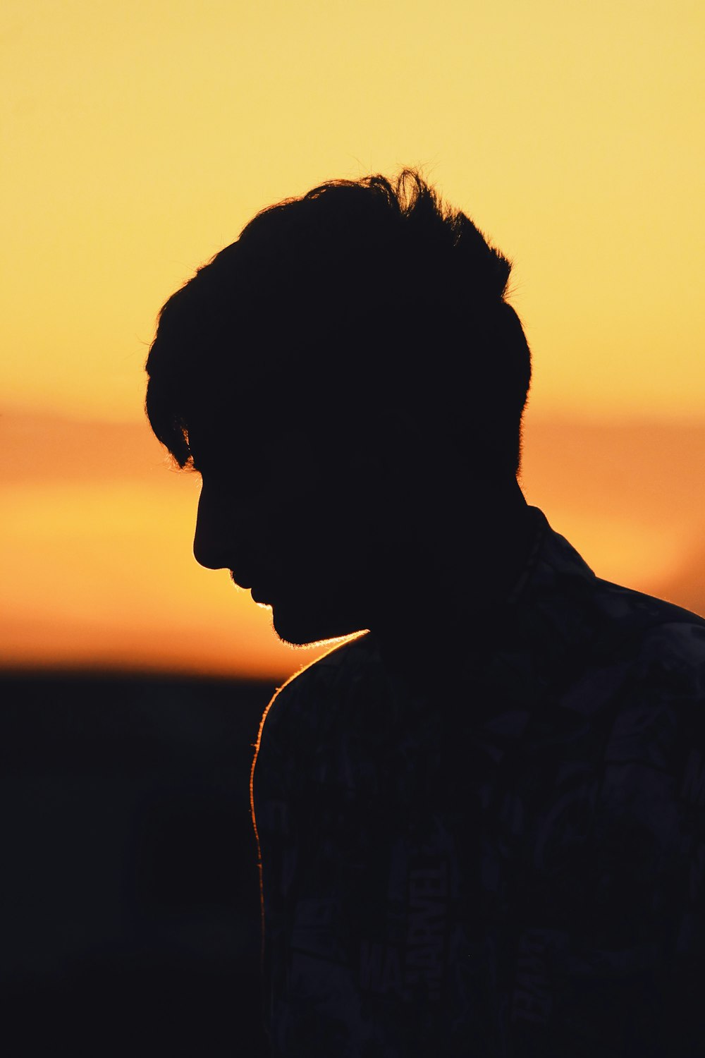 silhouette of man with earbuds during sunset