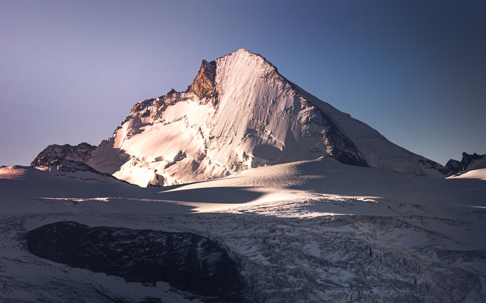 Schneebedeckter Berg unter blauem Himmel tagsüber