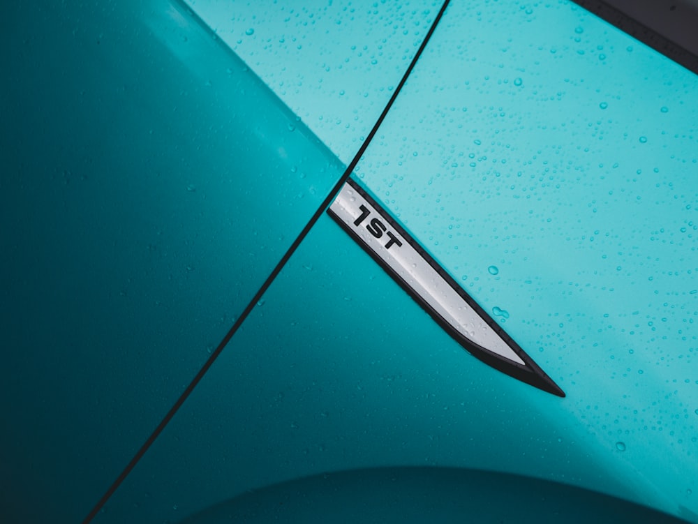 a close up of the hood of a blue car