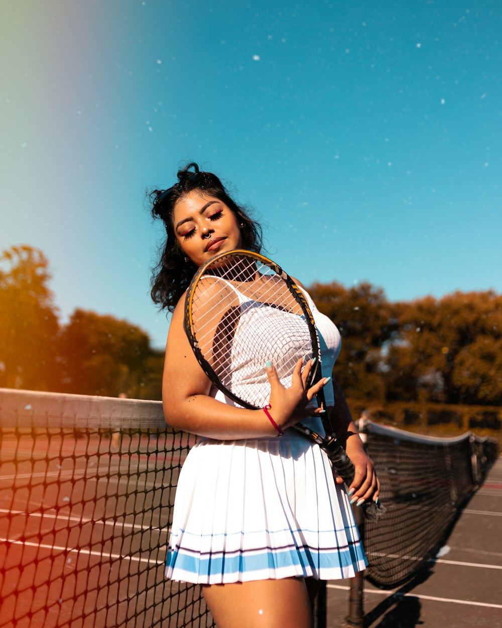 woman in white dress holding basketball hoop