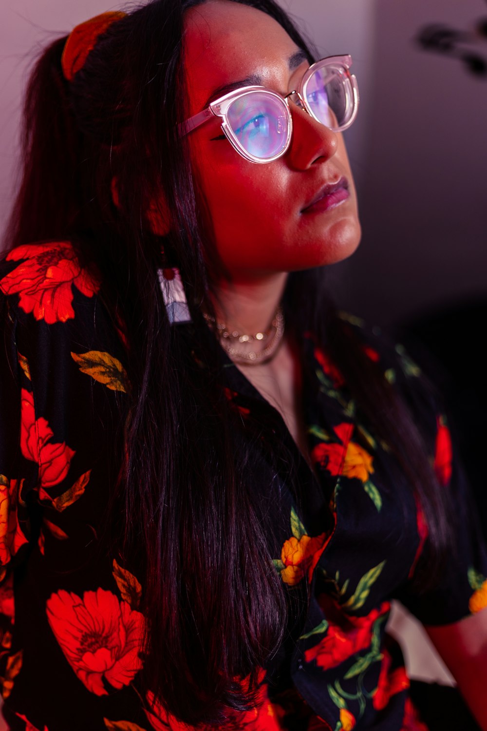 woman in black and red floral shirt wearing sunglasses