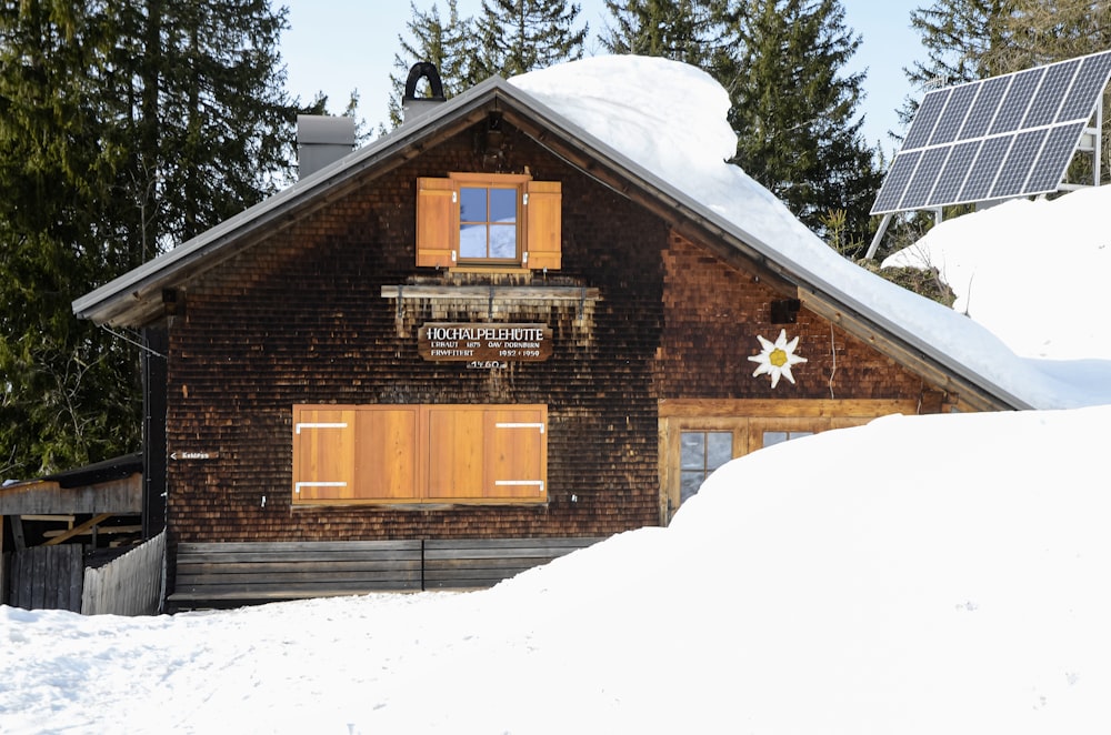 brown brick building with snow covered ground and trees during daytime