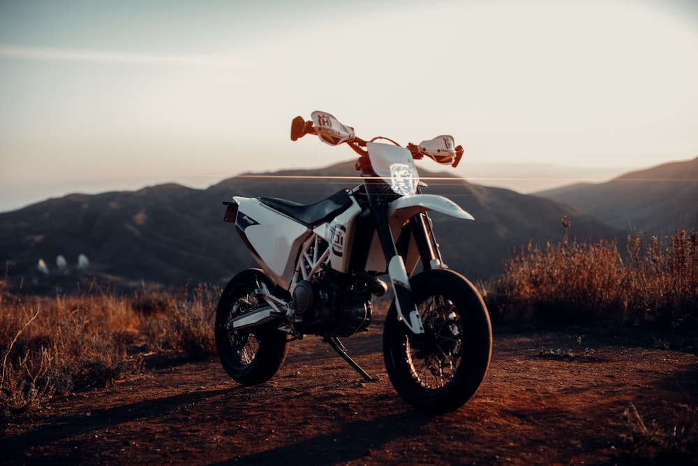 black and white motorcycle on brown field during daytime