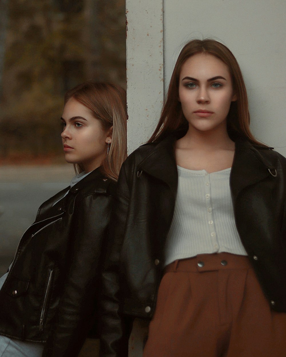 woman in black jacket and brown skirt