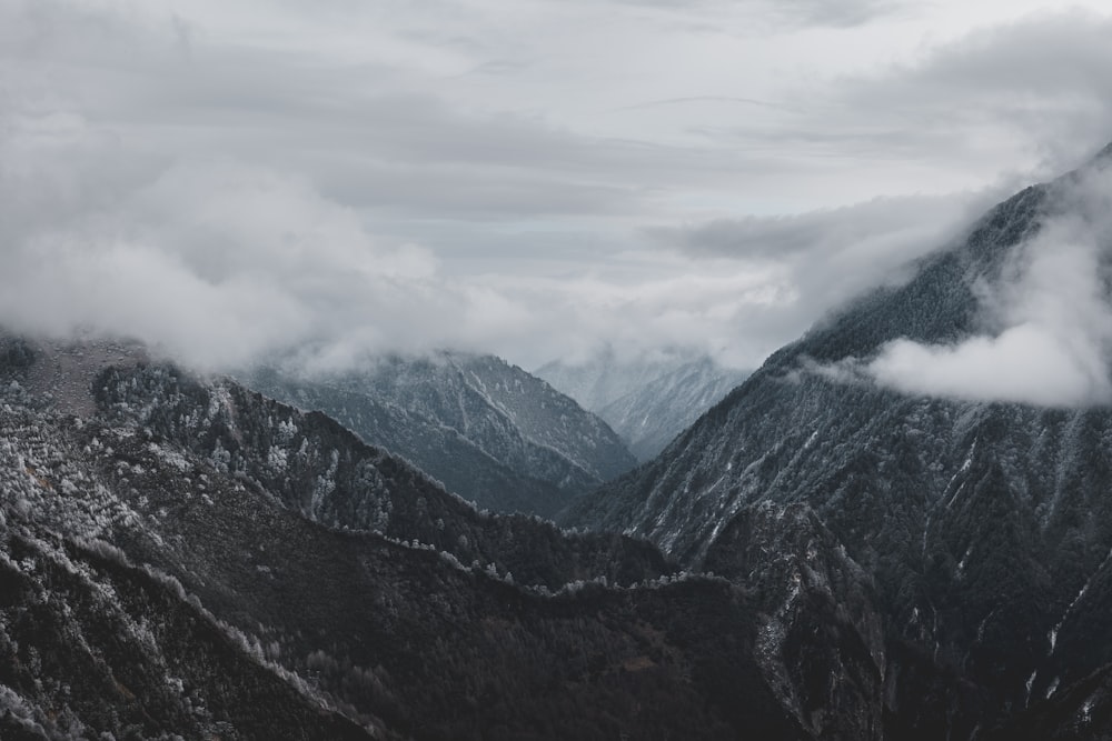 black and white mountains under white clouds