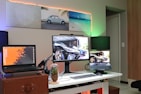 black flat screen computer monitor on brown wooden desk