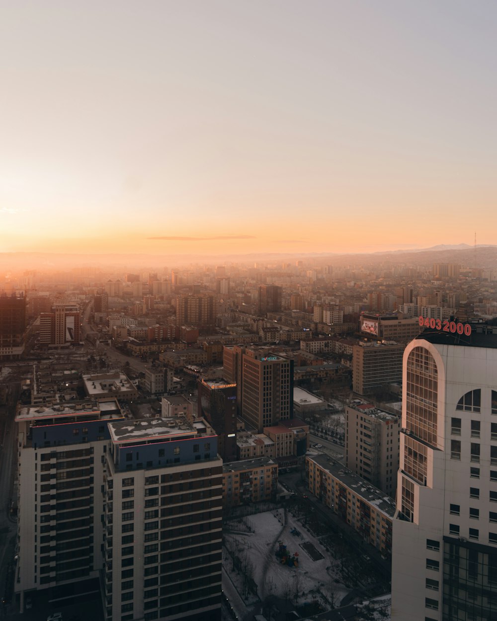 aerial view of city buildings during sunset