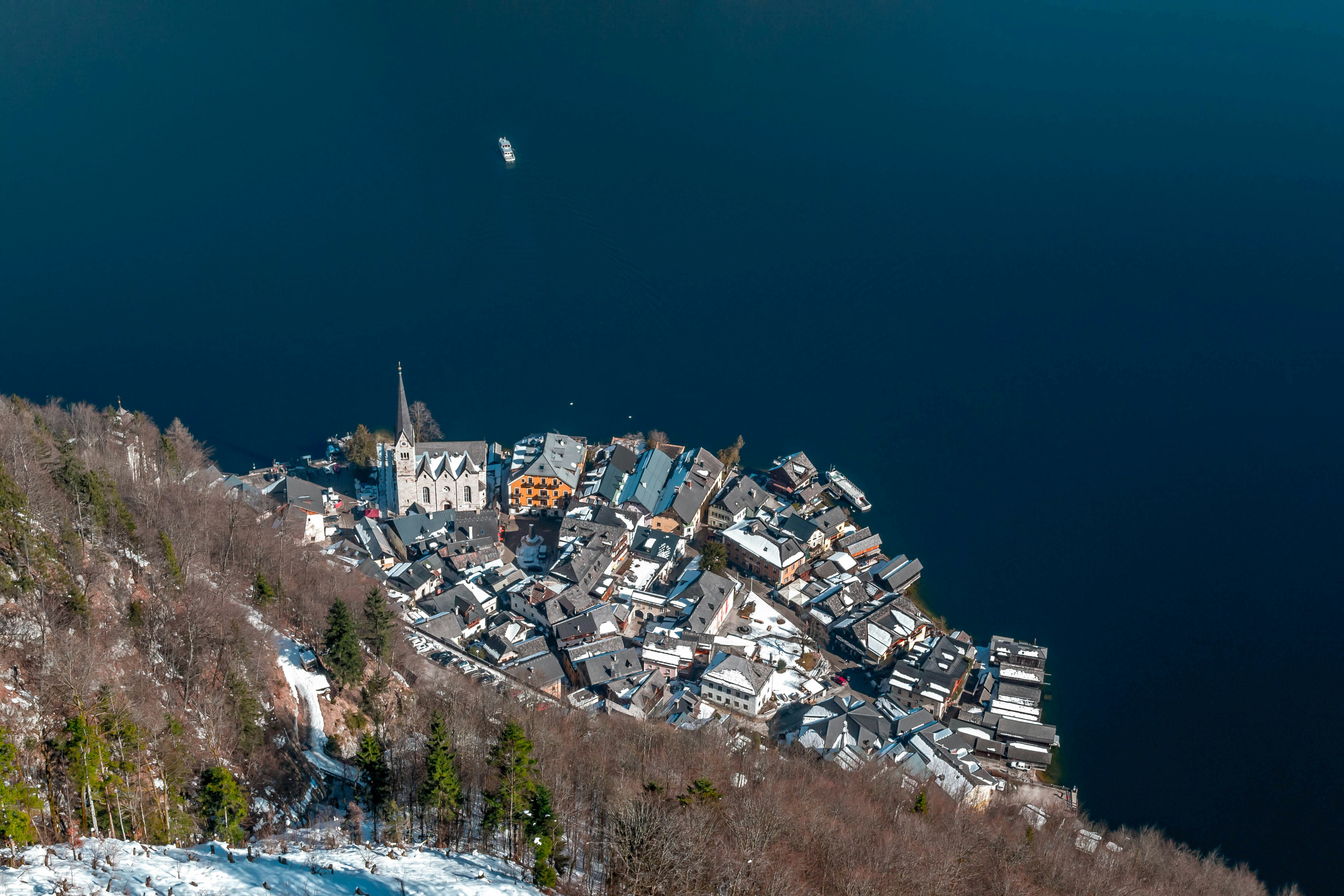 white and brown houses near body of water during daytime