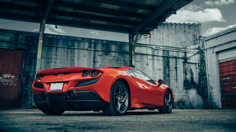 red ferrari 458 italia parked near building