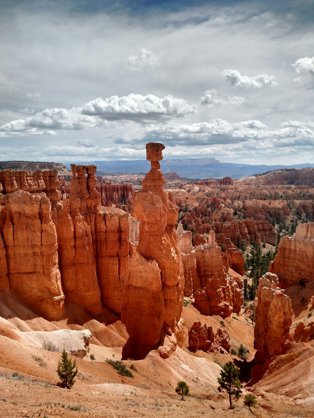 brown rock formation under white clouds during daytime