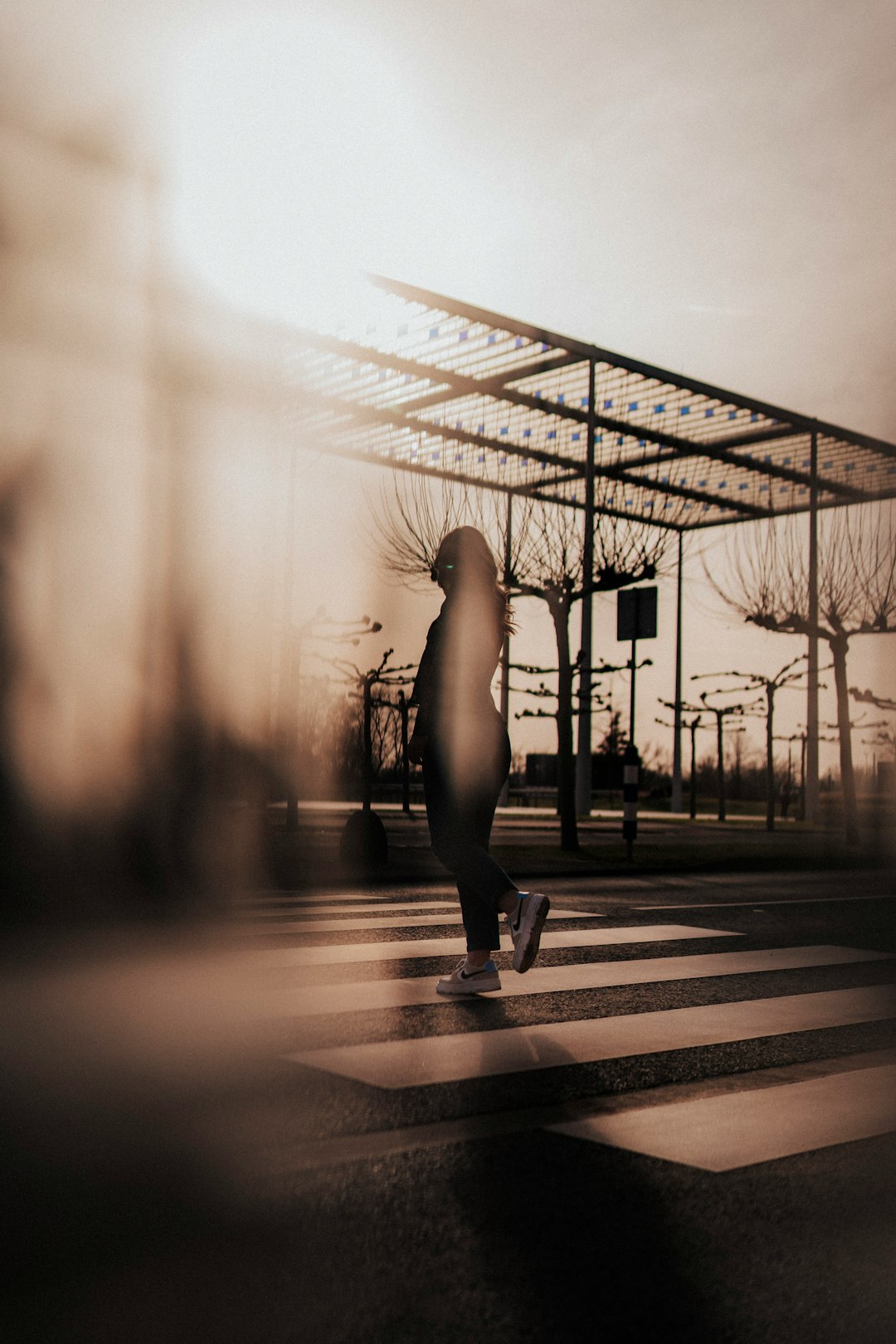 woman in black tank top and black leggings standing on sidewalk during daytime