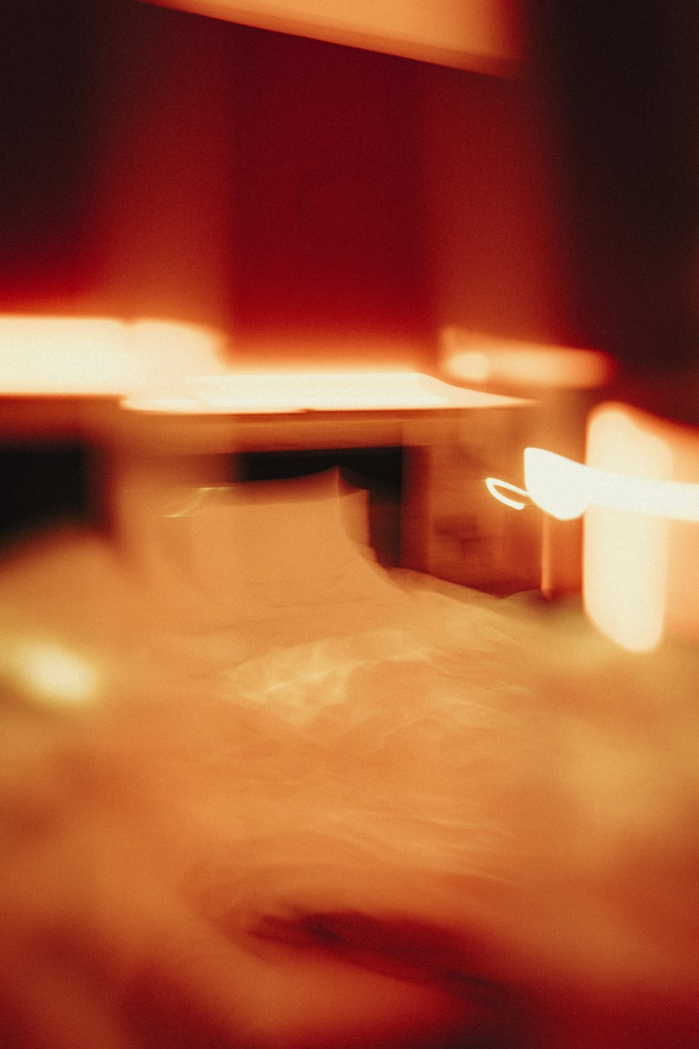 red light bokeh on brown wooden surface