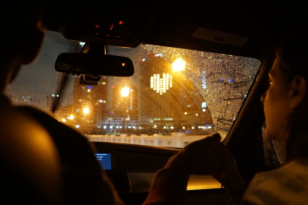 person holding black smartphone in car