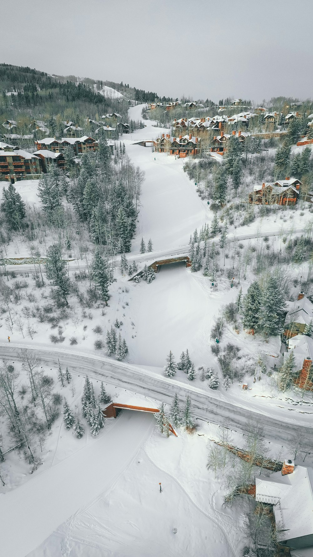 brown wooden house on snow covered mountain during daytime