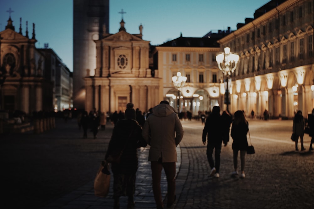 people walking on street during night time