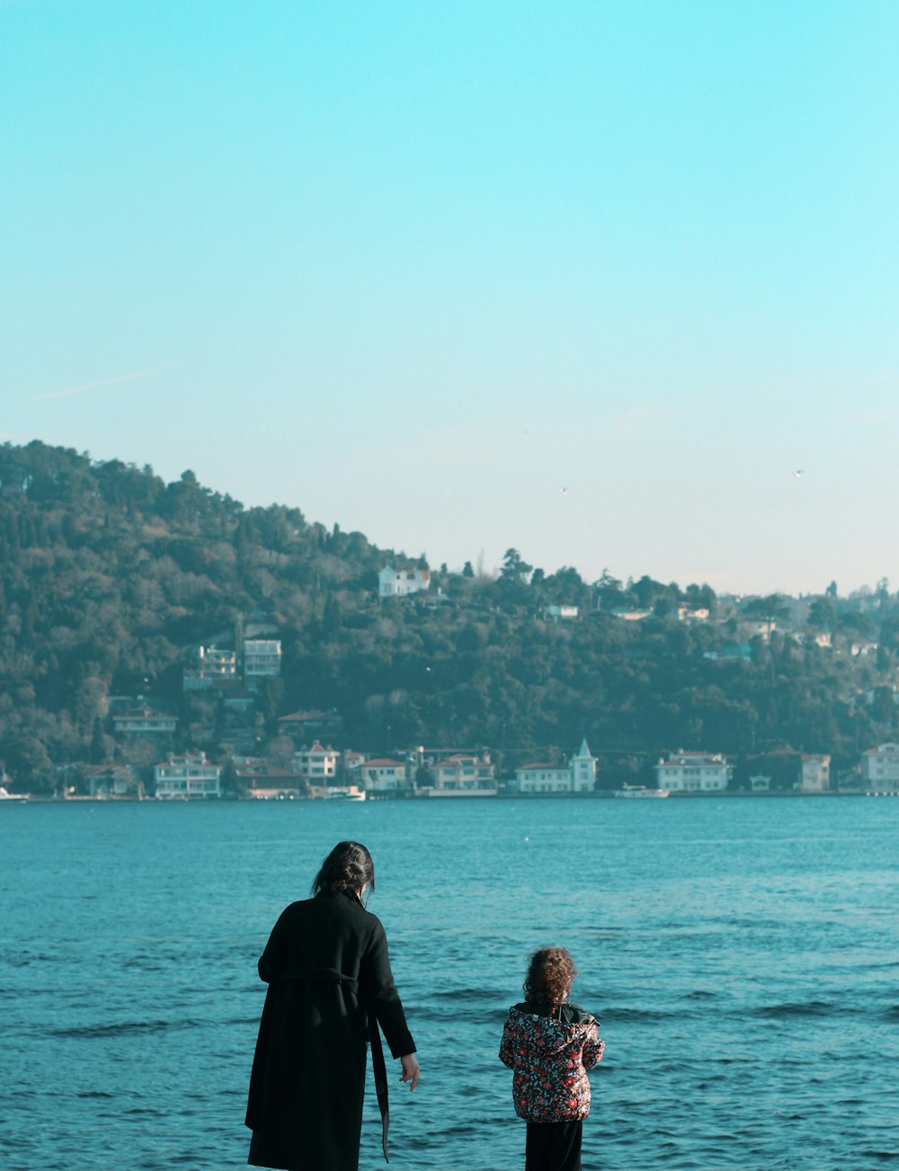 couple standing on the beach during daytime