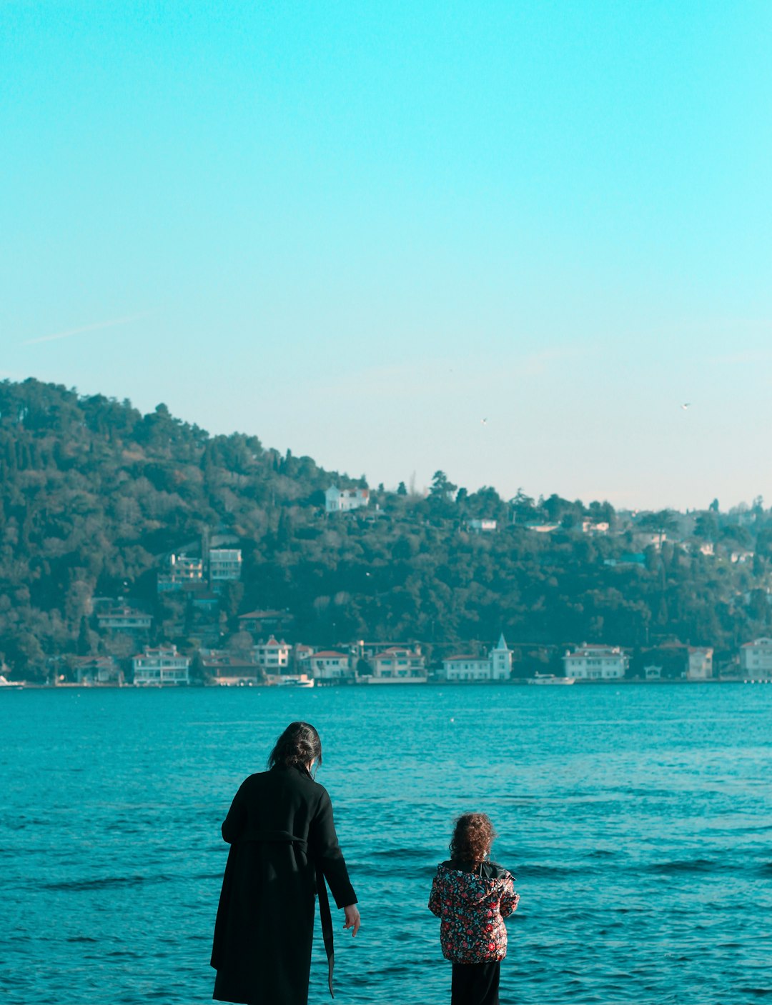 couple standing on the beach during daytime