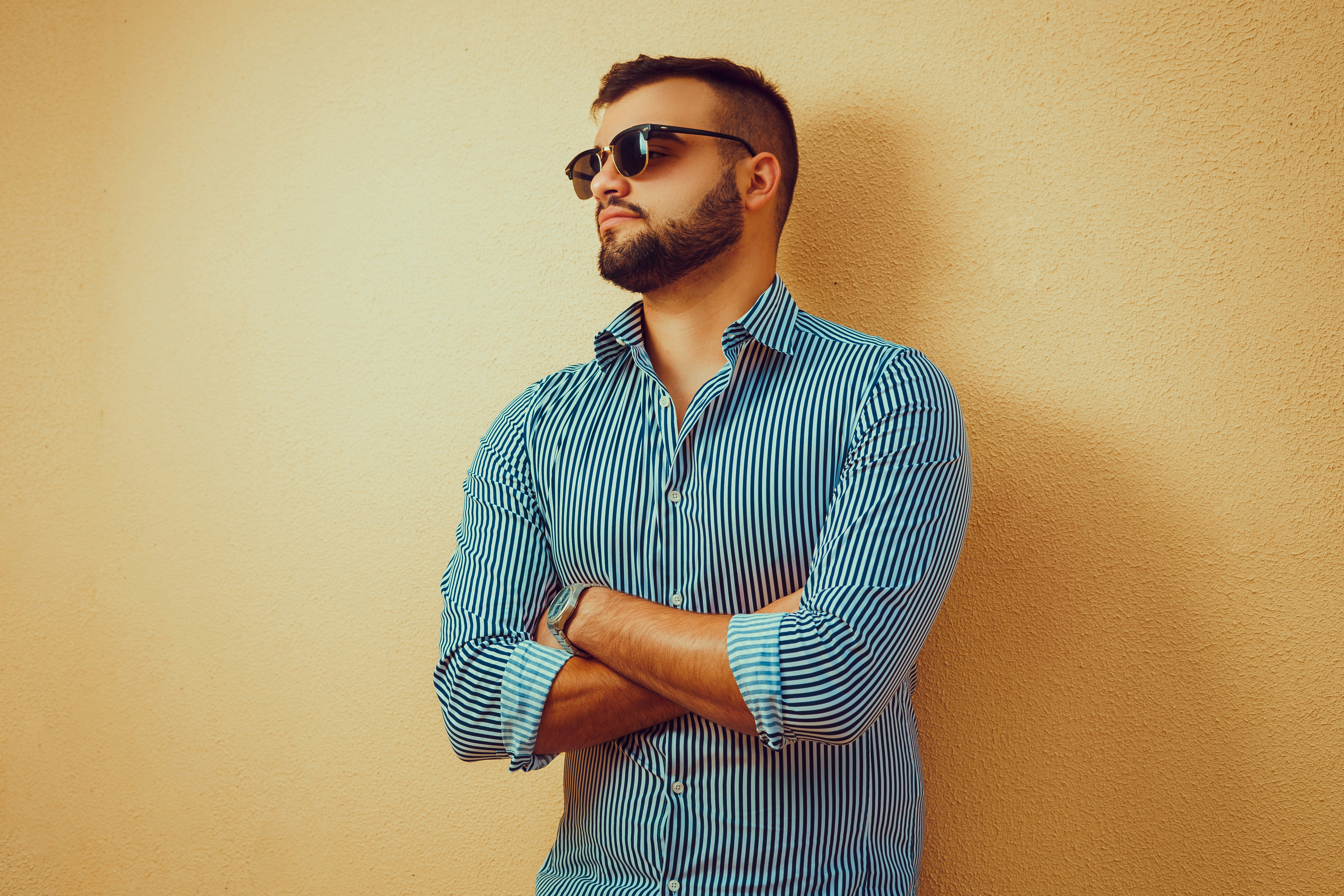 man in blue and white striped button up shirt wearing black sunglasses