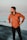 man in brown zip up jacket standing on beach during daytime